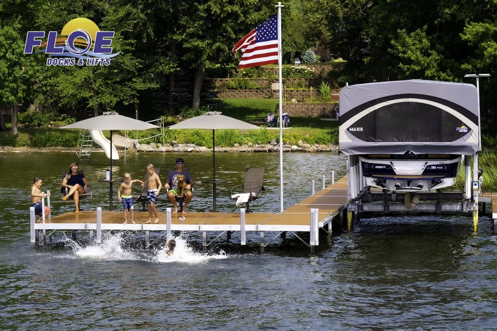 FLOE Internationa's dock and boat lift on a lake, kids playing on the dock.